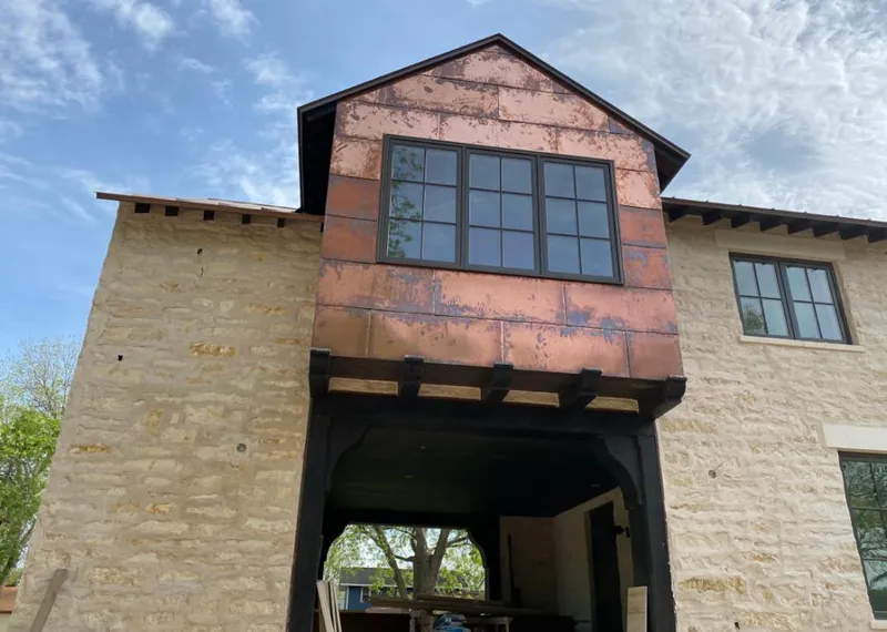 Copper metal panel facade on a stone building for Skylight Installation in Richland