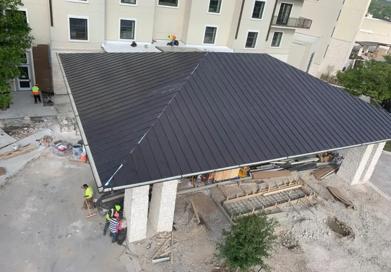 Metal roofing installation team working on a commercial building in Richland